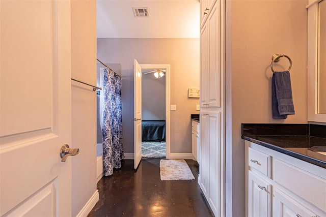 bathroom featuring vanity, shower / bath combination with curtain, and concrete floors