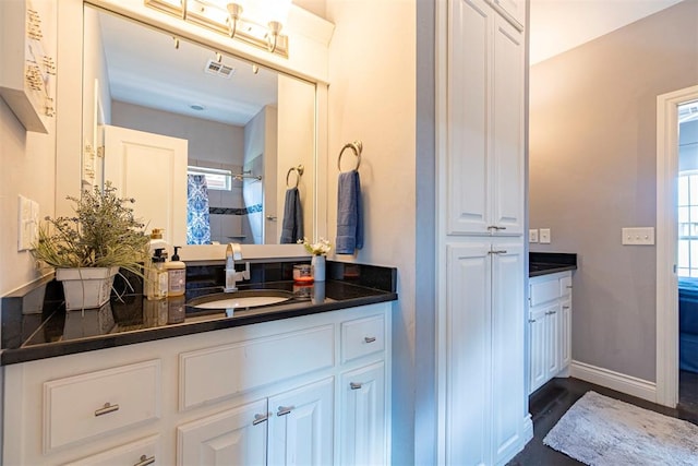 bathroom featuring vanity, hardwood / wood-style flooring, and a shower with shower curtain