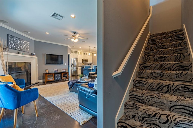 living room featuring crown molding and ceiling fan