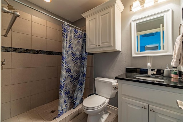 bathroom with vanity, curtained shower, and toilet