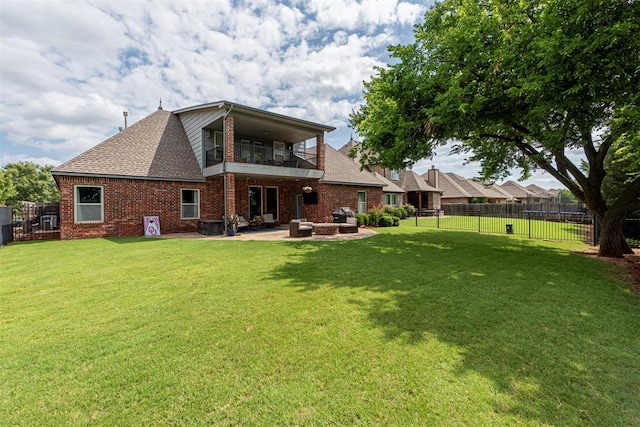 back of house with a patio, a balcony, and a lawn