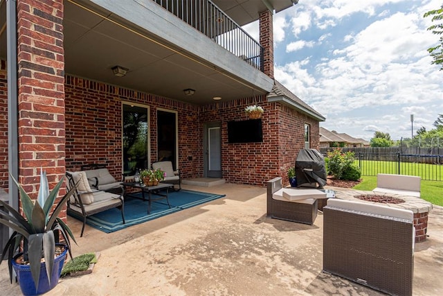 view of patio featuring an outdoor living space, grilling area, and a balcony