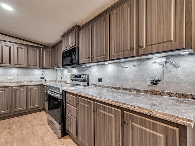 kitchen with black microwave, lofted ceiling, dark brown cabinets, stainless steel electric stove, and tasteful backsplash