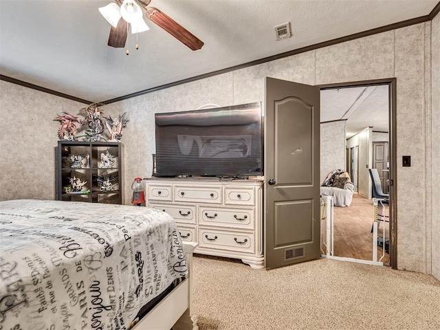 bedroom featuring carpet, visible vents, a ceiling fan, and ornamental molding