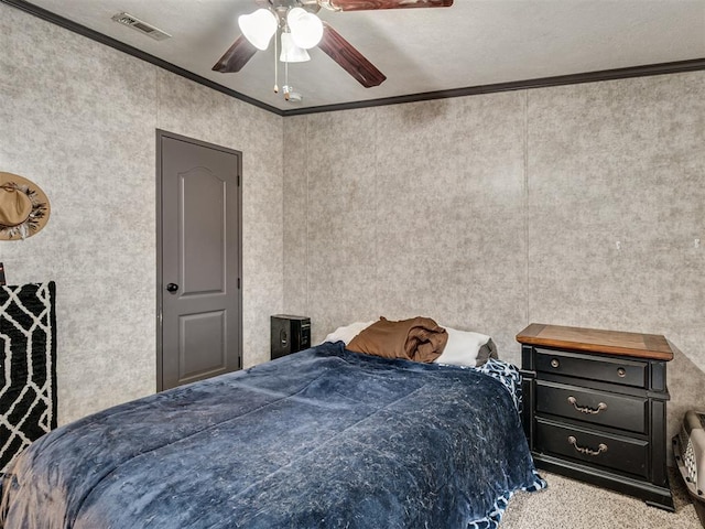 bedroom with a ceiling fan, visible vents, and crown molding
