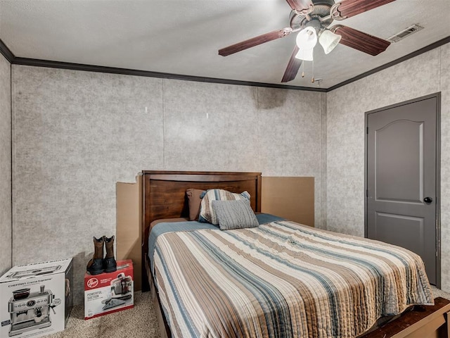 carpeted bedroom with a ceiling fan, visible vents, and crown molding