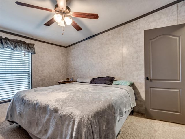 bedroom with a ceiling fan, light carpet, and crown molding