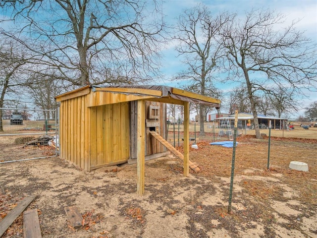 view of outbuilding with an outbuilding and fence