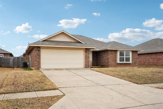 ranch-style home featuring a garage and a front lawn