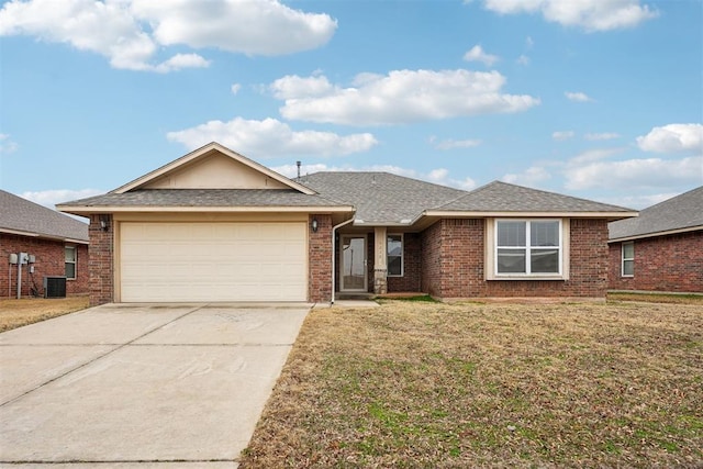 ranch-style house featuring a garage and a front lawn