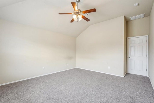 carpeted empty room featuring vaulted ceiling and ceiling fan