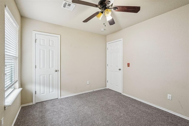 unfurnished bedroom with ceiling fan and carpet flooring