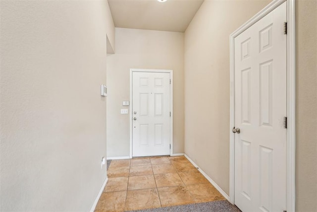 doorway featuring light tile patterned flooring