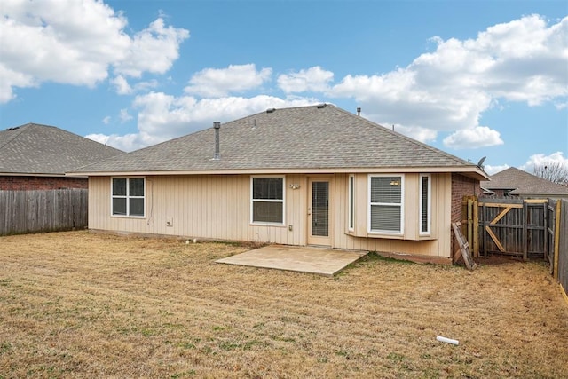 rear view of property featuring a yard and a patio area