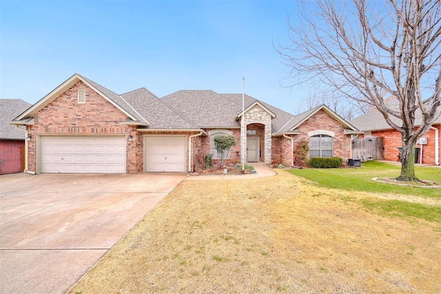 ranch-style house featuring a garage and a front lawn