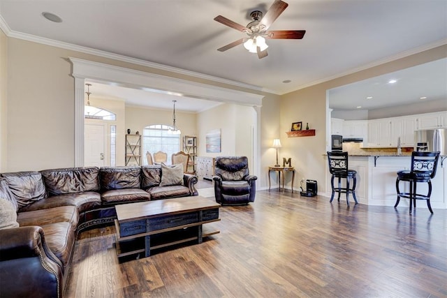 living room with crown molding, hardwood / wood-style flooring, and ceiling fan