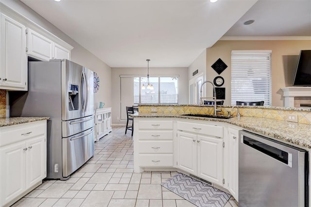 kitchen with tasteful backsplash, white cabinetry, appliances with stainless steel finishes, and sink