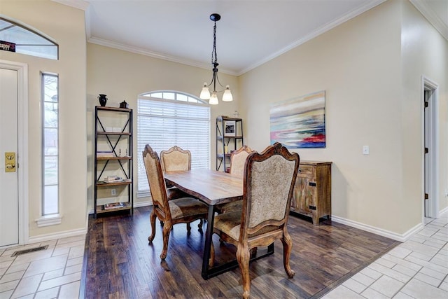 dining room with ornamental molding, an inviting chandelier, and light hardwood / wood-style floors