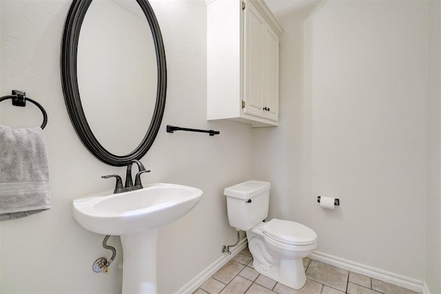 bathroom with tile patterned flooring and toilet