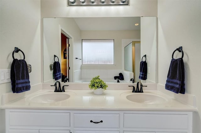 bathroom with a shower with door and vanity