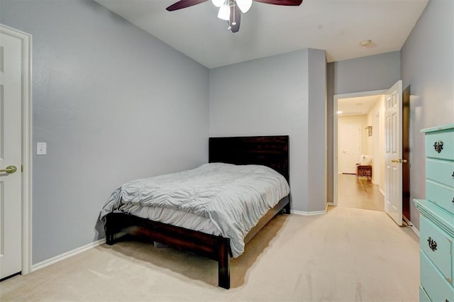 bedroom with ceiling fan and light carpet