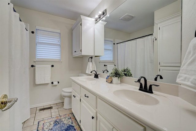 bathroom with vanity, tile patterned floors, and toilet