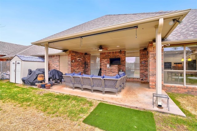 view of patio featuring outdoor lounge area, ceiling fan, and a storage unit