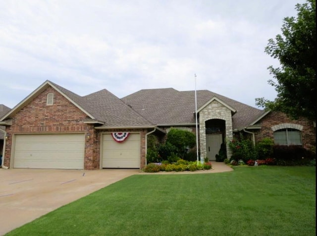 ranch-style house with a garage and a front lawn