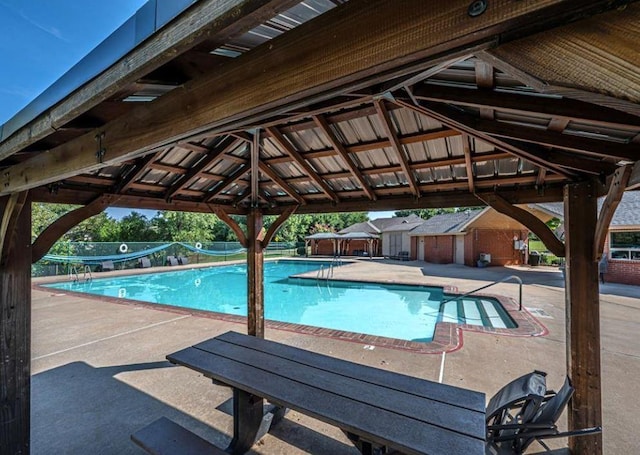 view of swimming pool with a patio