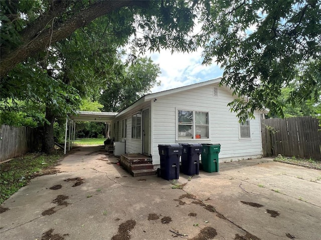 view of property exterior featuring a carport and a patio area