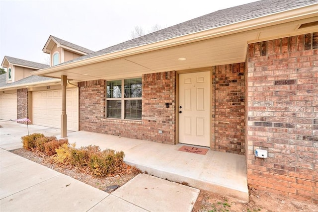 entrance to property with a porch and a garage