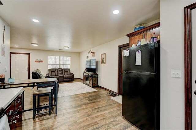 kitchen featuring black fridge and light wood-type flooring