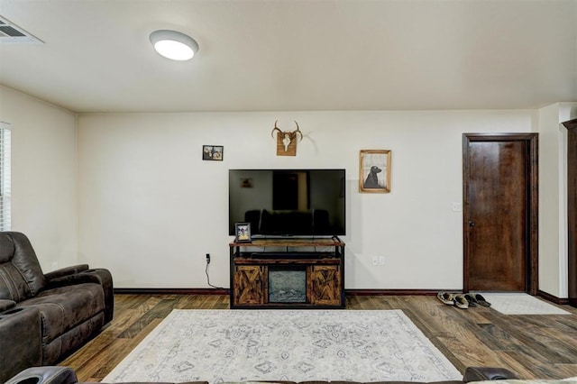 living room featuring dark wood-type flooring