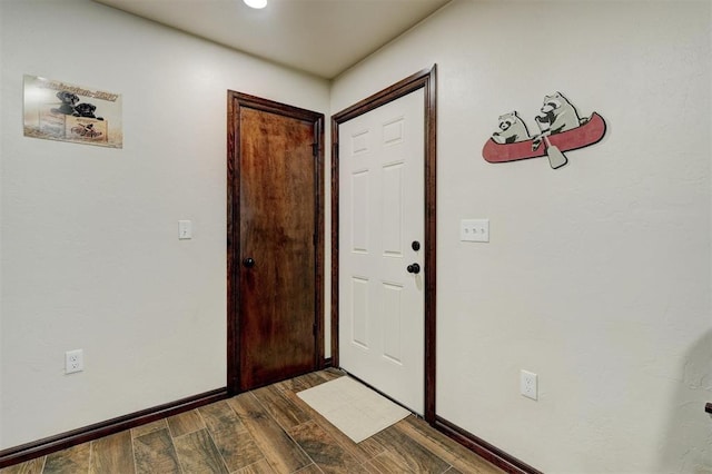 doorway with dark hardwood / wood-style flooring