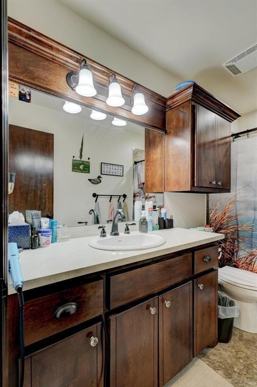 bathroom featuring vanity and toilet