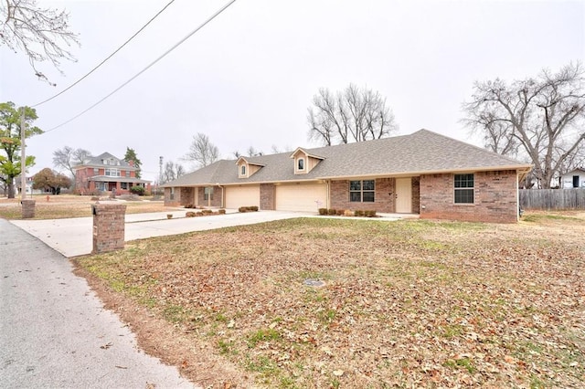 ranch-style home featuring a garage and a front yard