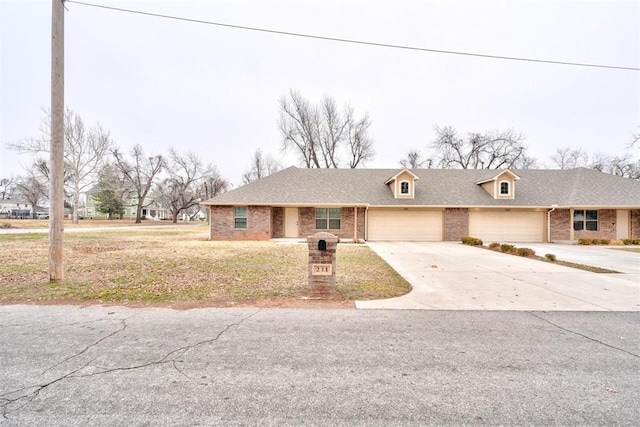 view of front of home featuring a garage and a front yard