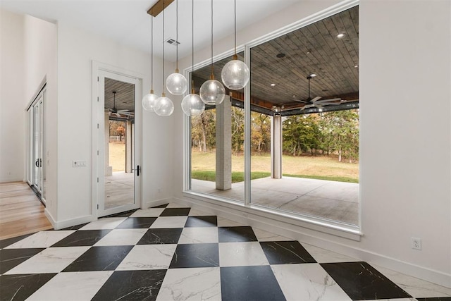 doorway featuring ceiling fan