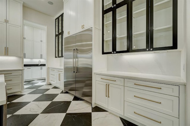 kitchen with built in fridge and white cabinets