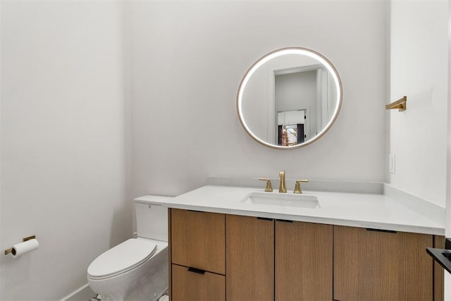 bathroom featuring vanity and toilet