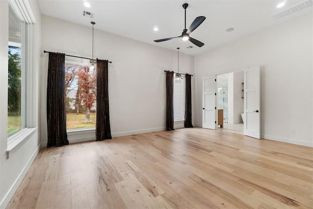 empty room featuring ceiling fan and light hardwood / wood-style flooring