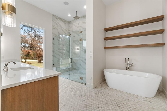 bathroom featuring vanity and shower with separate bathtub