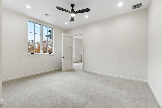 unfurnished bedroom with ceiling fan and light carpet