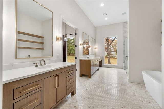 bathroom featuring vanity and separate shower and tub