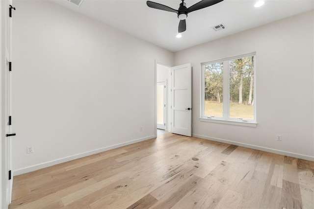 spare room featuring ceiling fan and light hardwood / wood-style flooring