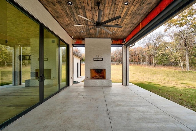 view of patio / terrace with an outdoor brick fireplace and ceiling fan