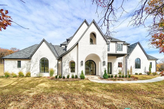 view of front of home featuring a front lawn and french doors