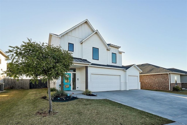 view of front of home with a garage, a front yard, and central air condition unit