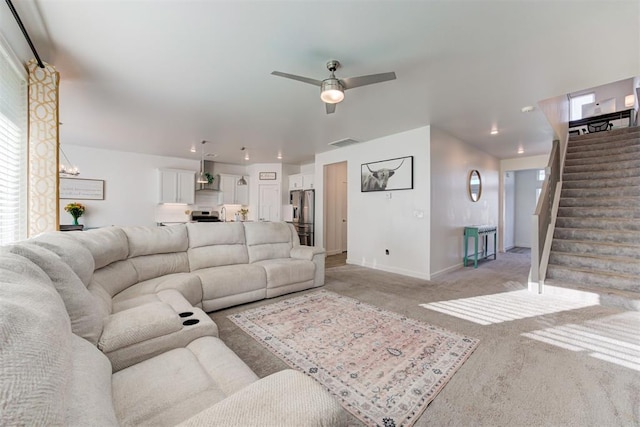 carpeted living room featuring ceiling fan