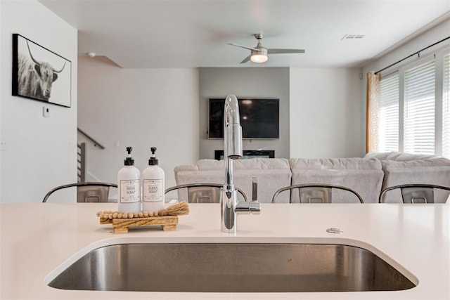 kitchen featuring ceiling fan and sink